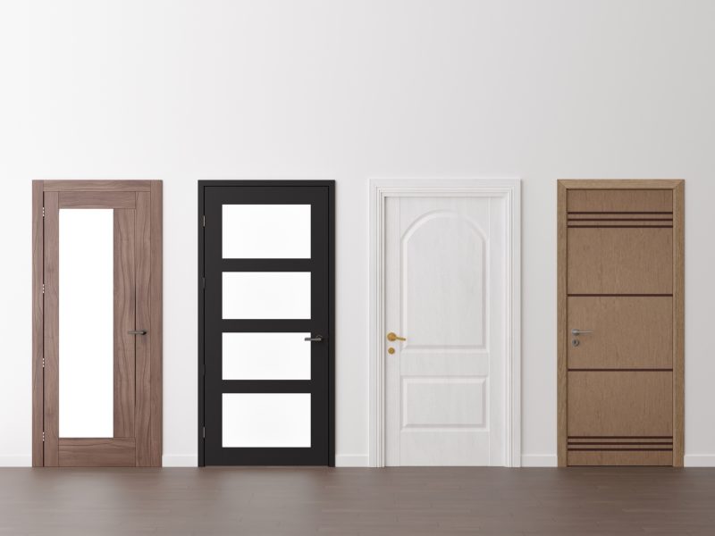 Various modern doors in empty room. Copy space for text, advertising. Production and trade of interior doors. Stylish internal door. Manufacture and sale. 3D rendering
